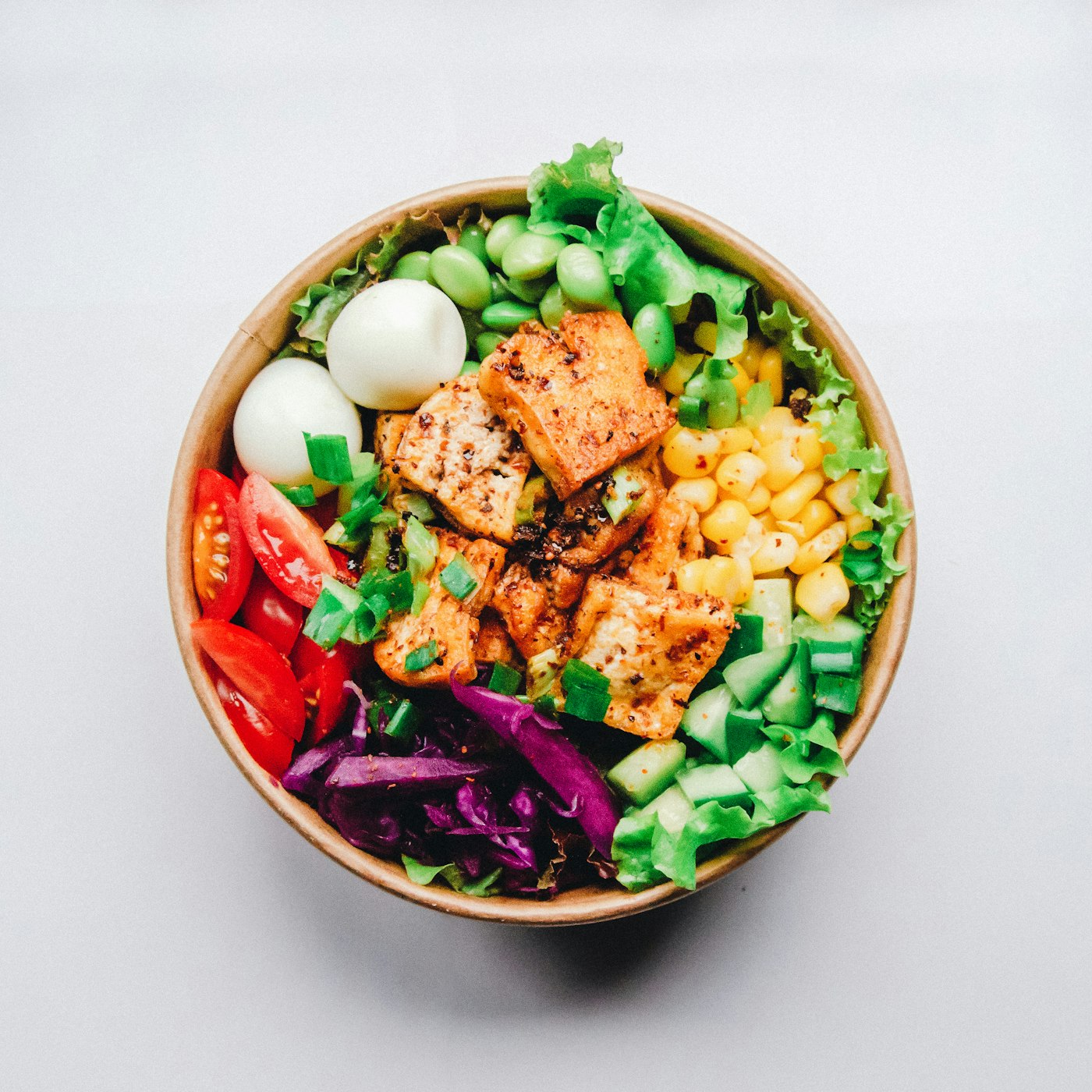 Top-down view of a prepared salad bowl on a cafeteria checkout