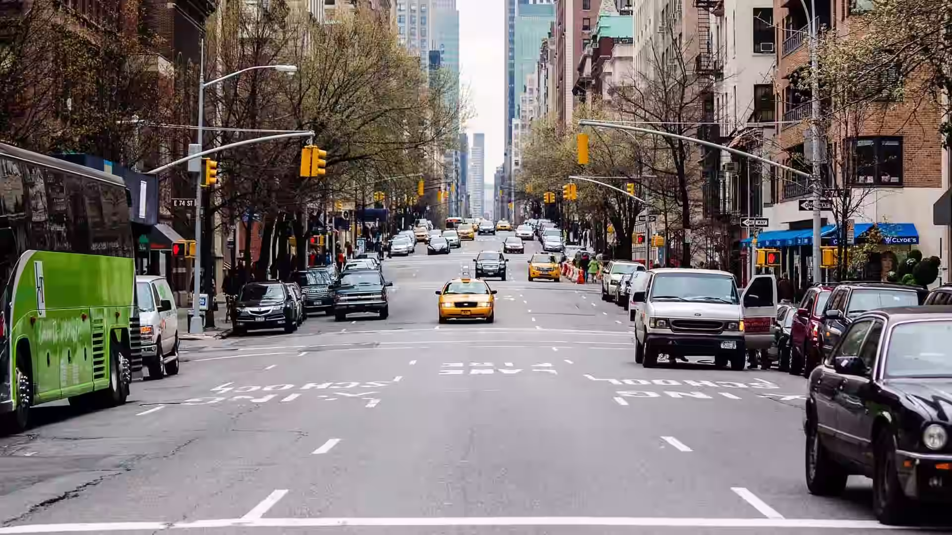 Traffic and pedestrians moving through a busy city street