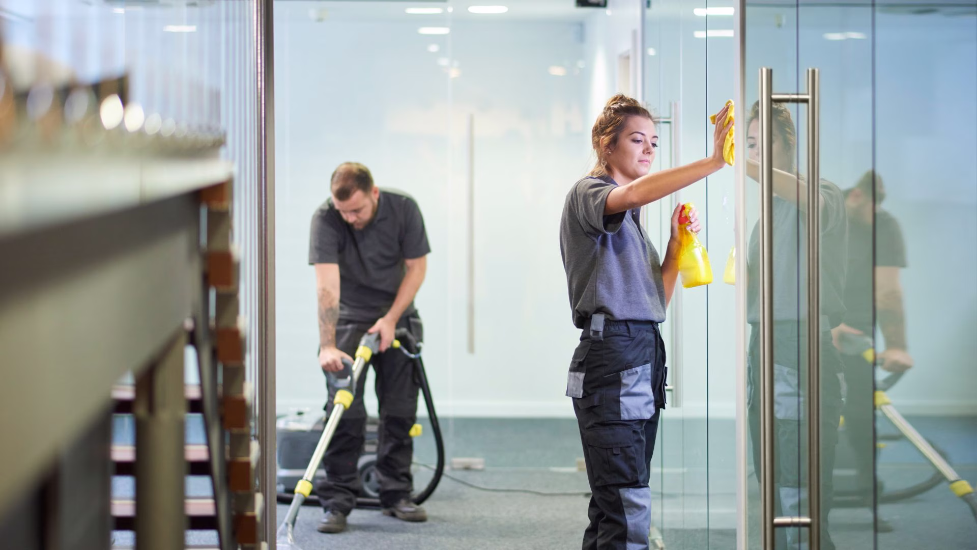 Cleaners working through an open-plan office, the kind of round captured as photo evidence in a Cleensight audit