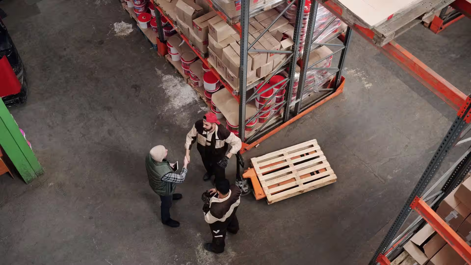A warehouse team working around pallets on a loading floor
